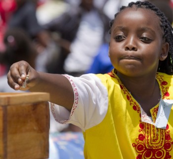 A girl makes an offering during Mass marking Missionary Childhood Day in Nairobi, Kenya, Feb. 19. Held annually by the Pontifical Missionary Childhood society, the outdoor service drew more than 30,000 children from around the Archdiocese of Nairobi. (CNS photo/Nancy Wiechec)
See KENYA-CHILDREN and KENYA-PMC