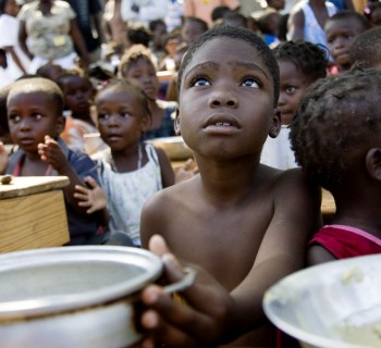 A child awaits for the distribution of meals by WFP (United Nations World Food Programme) in a make-shift camp in Jacmel January 28, 2010. An earthquake on January 12 killed some 200,000 people and devastated the impoverished country.      REUTERS/Marco Dormino/UN/MINUSTAH/Handout     (HAITI - Tags: DISASTER SOCIETY) FOR EDITORIAL USE ONLY. NOT FOR SALE FOR MARKETING OR ADVERTISING CAMPAIGNS