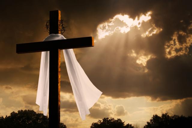 Dramatic Lighting on Christian Easter Cross As Storm Clouds Break