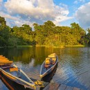 Two traditional wooden canoes at sunset in the Amazon River Basi