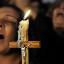 Coptic Christians carry a crucifix and chant prayers during a candlelight protest at Abassaiya Orthodox Cathedral in Cairo Oct. 16, one week after people were killed during clashes with soldiers and riot police. At least 26 people, mostly Christians, were killed Oct. 9 when troops broke up a peaceful protest against an earlier attack on a church in southern Egypt. (CNS photo/stringer via Reuters) (Oct. 18, 2011) See EGYPT-CHRISTIANS Oct. 10, 2011.