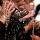 BAGHDAD, IRAQ - APRIL 7: Worshippers pray at a service for Pope John Paul II on April, 7, 2005 at a Catholic church in Baghdad, Iraq. Pope John Paul II died at his residence in the Vatican on April 2, aged 84 years old.  His funeral will be held in St. Peter's Square on Friday, April 8. Cardinals under the age of 80 will start the conclave on April 18, where a new Pope will be chosen. (Photo by Wathiq Khuzaie/Getty Images)