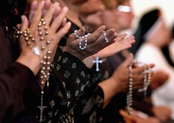 BAGHDAD, IRAQ - APRIL 7: Worshippers pray at a service for Pope John Paul II on April, 7, 2005 at a Catholic church in Baghdad, Iraq. Pope John Paul II died at his residence in the Vatican on April 2, aged 84 years old.  His funeral will be held in St. Peter's Square on Friday, April 8. Cardinals under the age of 80 will start the conclave on April 18, where a new Pope will be chosen. (Photo by Wathiq Khuzaie/Getty Images)