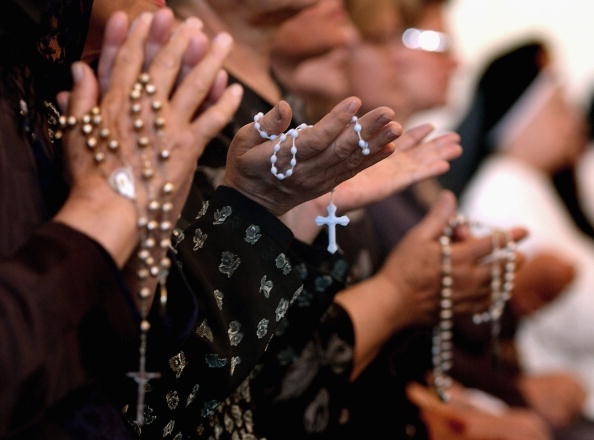 BAGHDAD, IRAQ - APRIL 7: Worshippers pray at a service for Pope John Paul II on April, 7, 2005 at a Catholic church in Baghdad, Iraq. Pope John Paul II died at his residence in the Vatican on April 2, aged 84 years old.  His funeral will be held in St. Peter's Square on Friday, April 8. Cardinals under the age of 80 will start the conclave on April 18, where a new Pope will be chosen. (Photo by Wathiq Khuzaie/Getty Images)