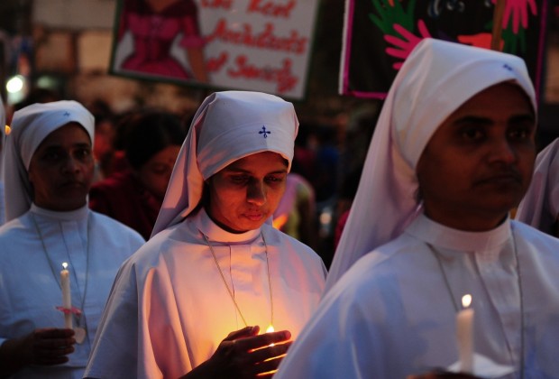 Indian Christians and social activists take part in a peace-rally and protest against the rape of a nun in Allahabad on March 16, 2015. Hundreds of priests, school girls and other protesters staged a peaceful rally March 16, 2015 in the Indian city of Kolkata to support an elderly nun who was gang-raped at her convent school. Nuns dressed in white habits joined other women of all backgrounds and ages, including girls still in their uniforms, to express their sorrow over the attack and anger over incessant levels of sexual assault in India. AFP PHOTO/ SANJAY KANOJIA        (Photo credit should read Sanjay Kanojia/AFP/Getty Images)