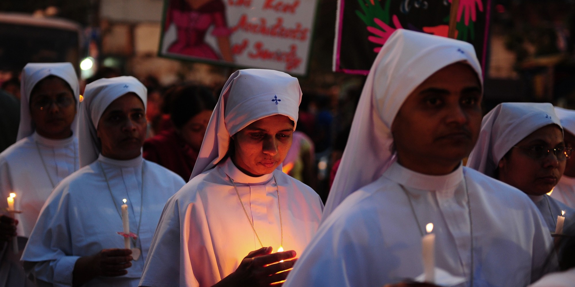 Indian Christians and social activists take part in a peace-rally and protest against the rape of a nun in Allahabad on March 16, 2015. Hundreds of priests, school girls and other protesters staged a peaceful rally March 16, 2015 in the Indian city of Kolkata to support an elderly nun who was gang-raped at her convent school. Nuns dressed in white habits joined other women of all backgrounds and ages, including girls still in their uniforms, to express their sorrow over the attack and anger over incessant levels of sexual assault in India. AFP PHOTO/ SANJAY KANOJIA        (Photo credit should read Sanjay Kanojia/AFP/Getty Images)