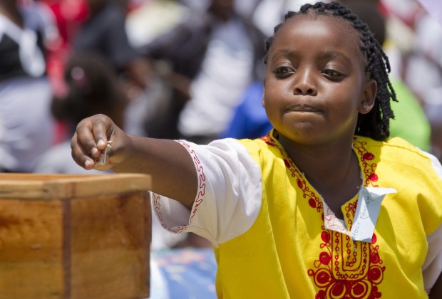 A girl makes an offering during Mass marking Missionary Childhood Day in Nairobi, Kenya, Feb. 19. Held annually by the Pontifical Missionary Childhood society, the outdoor service drew more than 30,000 children from around the Archdiocese of Nairobi. (CNS photo/Nancy Wiechec)
See KENYA-CHILDREN and KENYA-PMC