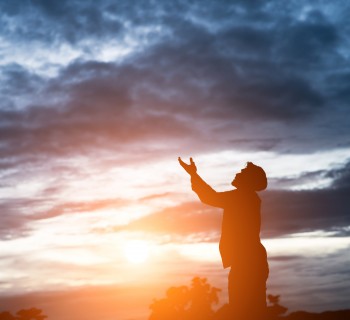 silhouette of handsome asian man praying.